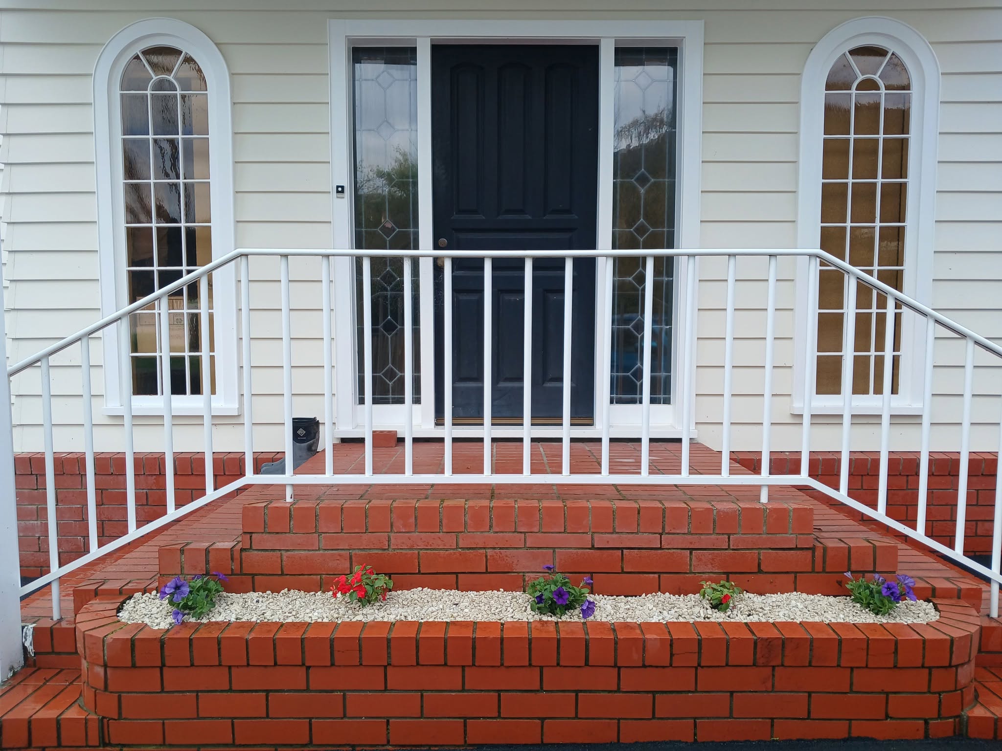Freshly groomed front entrance with tidy flower planting